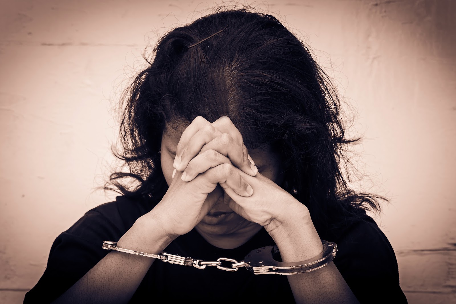 Inmate in prison praying for deliverance and freedom