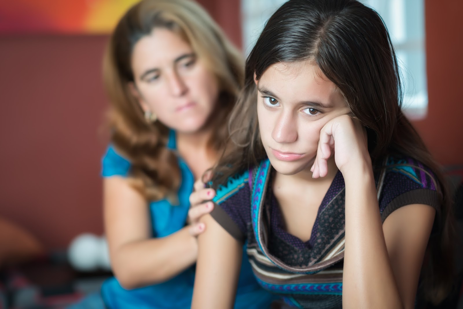 Hopeless girl sitting with her mother