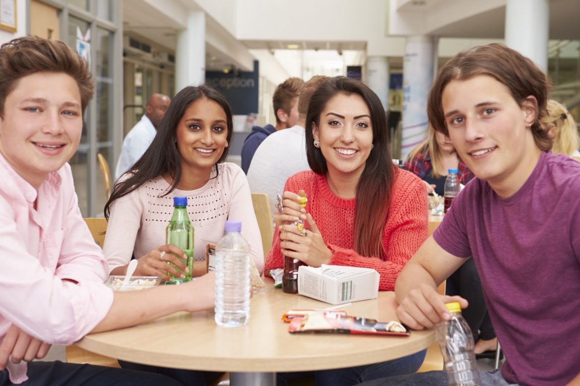 young adults gathering fellowship eating table Courtesy of Monkey Business ImagesShutterstockcom _284570330