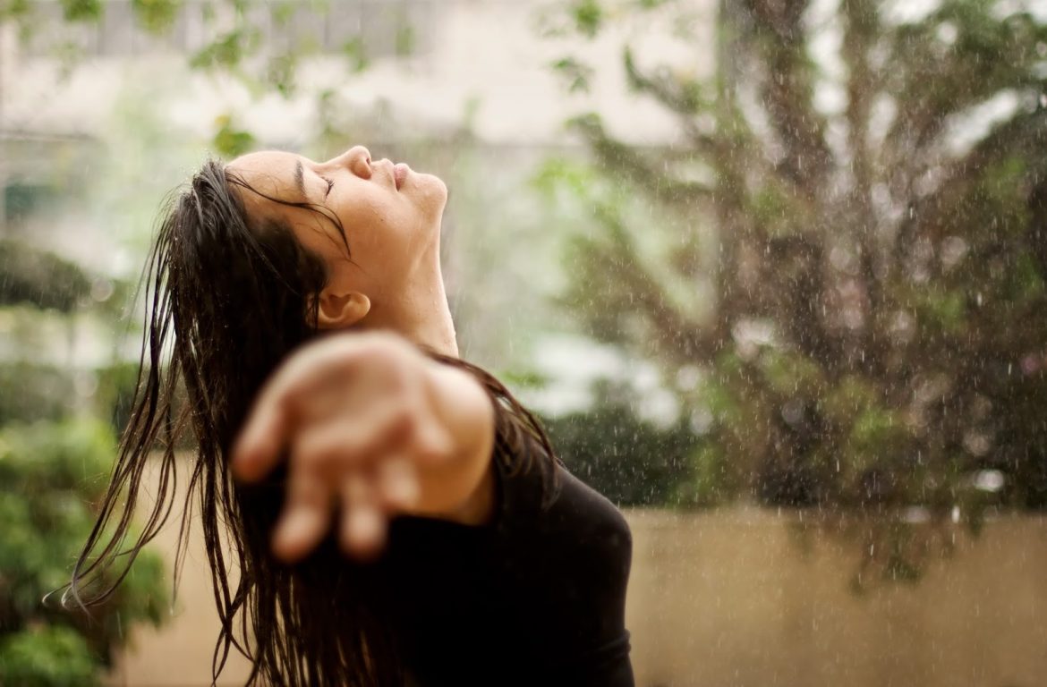drenching rain woman arms wide worship Courtesy of Shutterstock com Karen H. Ilagan_29374744
