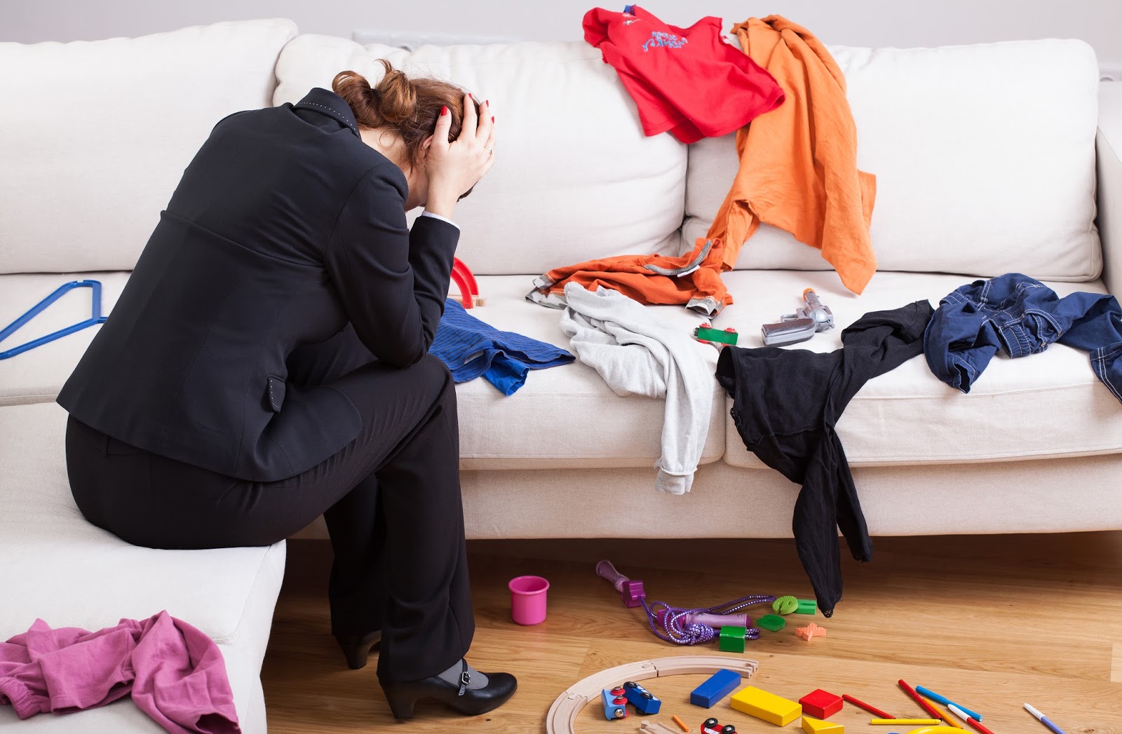 Overwhelmed single mother working in a messy home