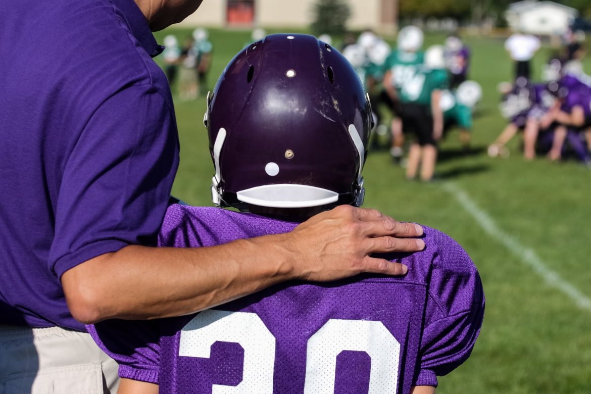 Coach side-lines hand on back shutterstock_735008377 resized